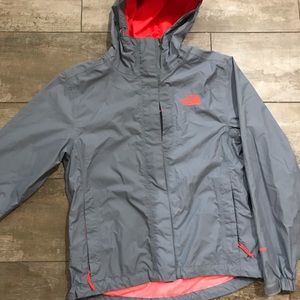 Grey and neon orange North Face rain jacket.